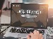 A person using a laptop with the words 'Job Search' on the screen, reflecting hands typing on the keyboard, with plants and a coffee cup on the desk.