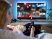 Smart TV showing a YouTube video being upscaled from standard definition to HD, with an on-screen notice about AI enhancement to improve picture clarity.