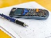 A close-up view of a scientific calculator and a blue pen on a sheet of paper with hand-written maths problems.