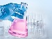 A hand in a blue surgical glove holding a conical flask with pink liquid, with scientific diagrams of atoms and the carbon cycle in the background.